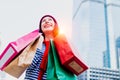 Portrait of an excited beautiful young girl wear shirt and wool hat holding many shopping bags and smile. With copy space. Royalty Free Stock Photo