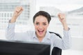 Portrait of an excited businesswoman clenching fists in office Royalty Free Stock Photo