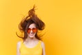 Portrait of excited cheerful laughter funny comic woman in orange glasses with fluttering hair copy space isolated on