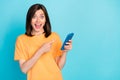 Portrait of excited cheerful person direct finger telephone instagram facebook whatsup isolated on blue color background