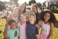 Portrait Of Excited Children At Summer Garden Fete