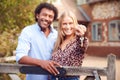 Portrait Of Excited Couple By Gate Holding House Keys Outside New Home In Countryside On Moving Day Royalty Free Stock Photo