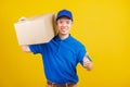 Delivery happy man logistic standing he smile wearing blue t-shirt and cap uniform holding parcel box show thumb up Royalty Free Stock Photo