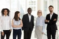 Portrait of excited diverse employees posing in company office Royalty Free Stock Photo