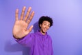 Portrait of excited funky man beaming smile arm palm waving give high five clap you isolated on purple color background