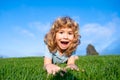 Portrait of a excited funny boy in the park. Funny little boy playing in garden backyard laughing and having fun. Summer Royalty Free Stock Photo