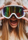 Portrait of excited funny woman snowboarder or skier in snow goggles. Royalty Free Stock Photo