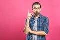 Portrait of an excited happy man pointing finger up at copyspace isolated on a pink background. Copy space Royalty Free Stock Photo