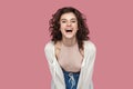 Portrait of excited happy positive beautiful brunette young woman with curly hairstyle in casual style standing, looking at camera Royalty Free Stock Photo