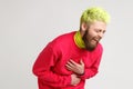 Portrait of excited happy yellow-haired man with beard, dresses in casual red sweater, laughing loud, hearing really funny thing,