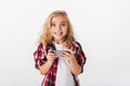 Portrait of an excited little girl holding mobile phone Royalty Free Stock Photo