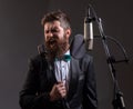 Portrait of excited man in a recording studio. Expressive bearded man in suit with microphone. Karaoke signer, musical Royalty Free Stock Photo