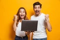 Portrait of excited man and woman screaming and clenching fists