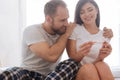 Portrait of excited married couple looking at pregnancy test