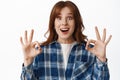 Portrait of excited redhead girl say yes, alright or okay, no problem, smiling amazed and praising something awesome