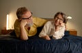 Portrait of excited senior married couple lying on bed and laughing Royalty Free Stock Photo