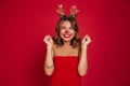 Portrait of an excited smiling girl wearing christmas deer costume Royalty Free Stock Photo