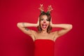 Portrait of an excited surprised girl wearing christmas deer costume Royalty Free Stock Photo