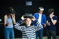 Surprised preteen boy playing virtual reality games with family