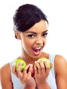 Portrait, excited and woman with apple, nutrition and sustainable eating to lose weight in studio. Fruit, face and girl