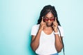 Portrait of excited young african female in sunglasses on blue background Royalty Free Stock Photo