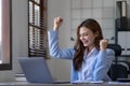 Portrait of an excited young asian girl using laptop computer and celebrating success for online. Royalty Free Stock Photo