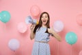 Portrait of excited young attaractive woman wearing blue dress holding megaphone showing thumb up on pink background Royalty Free Stock Photo