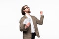 Portrait of an excited young businessman dressed in suit showing money banknotes isolated over gray background Royalty Free Stock Photo