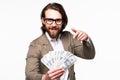 Portrait of an excited young businessman dressed in suit showing money banknotes isolated over gray background Royalty Free Stock Photo