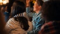 Portrait of an Excited Young Female in a Jeans Coat Standing in a Crowd of Sports Fans in a Pub