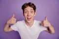 Portrait of excited young guy show thumbs-up kie fine ad choice select isolated over violet color background