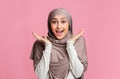 Portrait of excited young islamic girl in hijab exclaiming in amazement Royalty Free Stock Photo