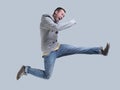 Funny cheerful happy man jumping in air over gray background Royalty Free Stock Photo