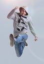 Funny cheerful happy man jumping in air over gray background Royalty Free Stock Photo