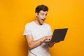 Portrait of an excited young man using laptop Royalty Free Stock Photo