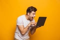 Portrait of an excited young man using laptop Royalty Free Stock Photo