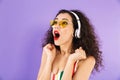 Portrait of an excited young woman dressed in swimsuit