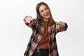 Portrait of excited young woman pointing fingers at camera, congratulating you, praising, inviting people to event Royalty Free Stock Photo