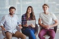 Portrait of executives sitting on office chair and using digital tablet Royalty Free Stock Photo