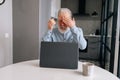 Portrait of exhausted bearded senior older businessman with grey hair touching forehead, feeling unwell due to computer Royalty Free Stock Photo