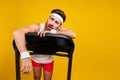 Portrait of exhausted weak young man struggling running treadmill empty space isolated on yellow color background Royalty Free Stock Photo