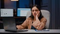 Portrait of exhausted workaholic manager checking economic statistics using laptop computer Royalty Free Stock Photo