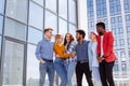 Group of multi ethnic youngsters chilling in urban outdoor background Royalty Free Stock Photo