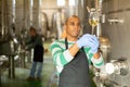 Latin american winemaker inspecting quality of wine at winery