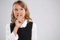 Portrait of an expressive beautiful young girl who put her finger to her lips, indicating that it is necessary to behave quietly. Royalty Free Stock Photo