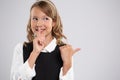 Portrait of an expressive beautiful young student who put her finger to her lips to create a gesture of attention Royalty Free Stock Photo