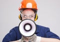 Portrait of Expressive Caucasian Female With Loudspeaker Horn Shouting In Hardhat Royalty Free Stock Photo