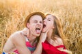 Portrait of expressive couple embraces in the field