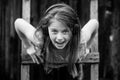 Portrait of expressive little girl enjoys music with headphones. Black and white photo.