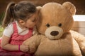 Portrait of expressive little girl hugging her toy bear